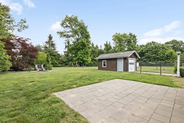 768 Plymouth St, Abington, MA 02351 - view of yard featuring a playground, an outbuilding, a garage, a patio area, and view of wooded area