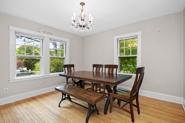 768 Plymouth St, Abington, MA 02351 - dining space with a chandelier, baseboards, and light wood-style floors