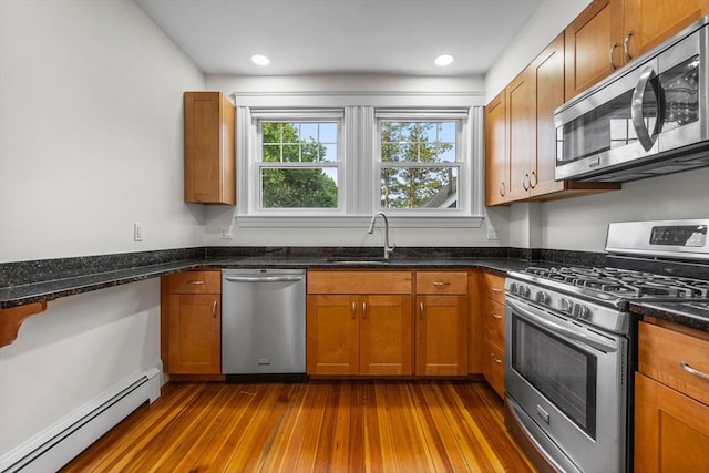 37 Fountain Rd Unit 1, Arlington, MA 02476 - kitchen featuring appliances with stainless steel finishes, a baseboard radiator, a sink, and brown cabinets