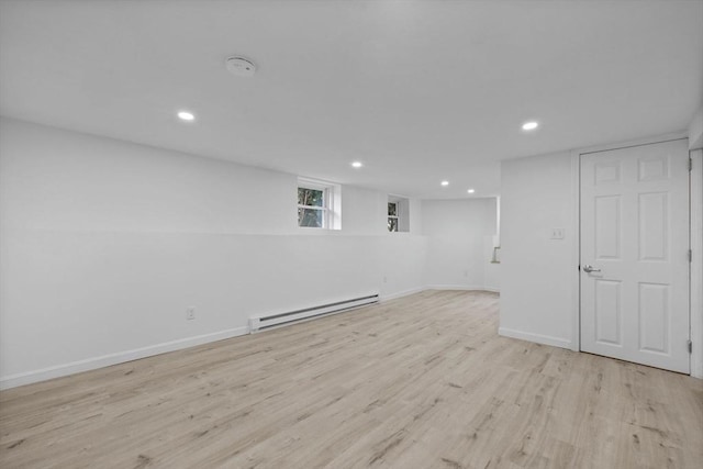 37 Fountain Rd Unit 1, Arlington, MA 02476 - below grade area with a baseboard radiator, light wood finished floors, recessed lighting, and baseboards