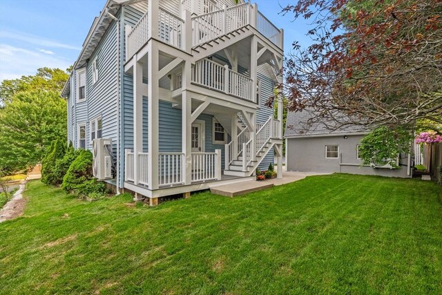 37 Fountain Rd Unit 1, Arlington, MA 02476 - back of house with a balcony, a yard, and stairs