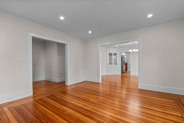 37 Fountain Rd Unit 1, Arlington, MA 02476 - spare room with a chandelier, light wood-style floors, baseboards, recessed lighting, and crown molding