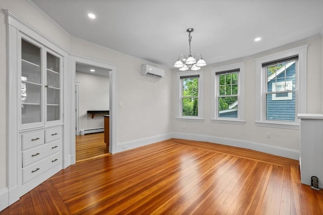 37 Fountain Rd Unit 1, Arlington, MA 02476 - unfurnished dining area featuring a baseboard radiator, a wall mounted AC, hardwood / wood-style flooring, baseboards, and a chandelier