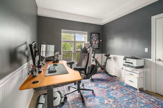 office area featuring wainscoting and a decorative wall