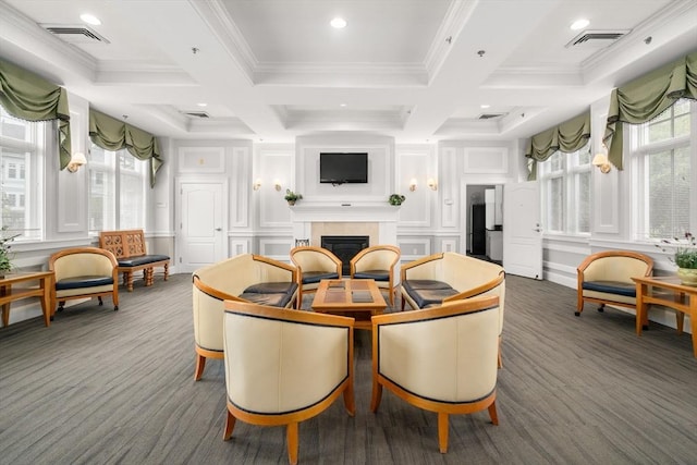 dining space featuring a decorative wall, a tile fireplace, ornamental molding, beamed ceiling, and coffered ceiling