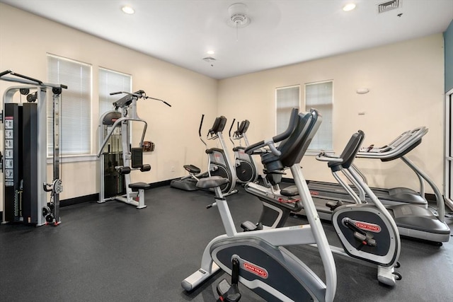 exercise room with recessed lighting and baseboards