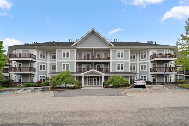 view of building exterior featuring uncovered parking