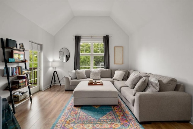 living room featuring vaulted ceiling and wood finished floors