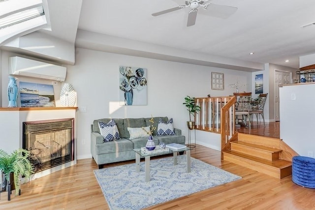 40 Oceanside Dr Unit 40, Hull, MA 02045 - living room with a fireplace, wood finished floors, recessed lighting, ceiling fan, and a wall unit AC