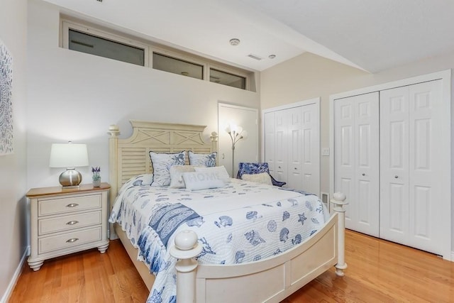 40 Oceanside Dr Unit 40, Hull, MA 02045 - bedroom featuring multiple closets, light wood-type flooring, and lofted ceiling