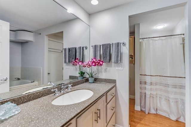 40 Oceanside Dr Unit 40, Hull, MA 02045 - full bathroom featuring vanity, wood finished floors, and a tub