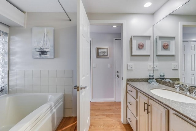 40 Oceanside Dr Unit 40, Hull, MA 02045 - bathroom with wood finished floors, a garden tub, and vanity