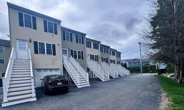 view of property with stairway and a garage