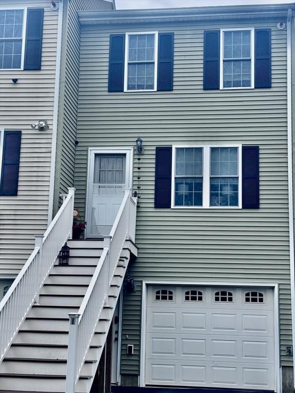 view of exterior entry featuring an attached garage