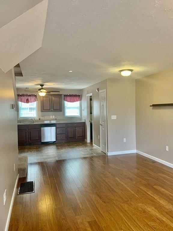 kitchen with dishwasher, dark wood-style flooring, baseboards, and light countertops
