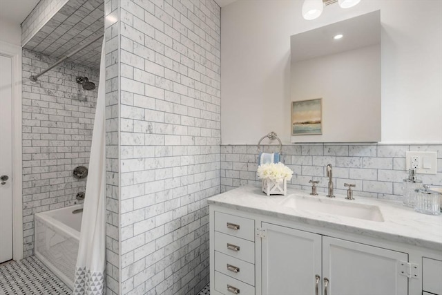 full bath featuring vanity, tile walls, and shower / tub combo with curtain