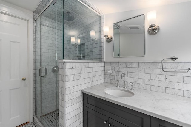 full bath with a shower stall and vanity