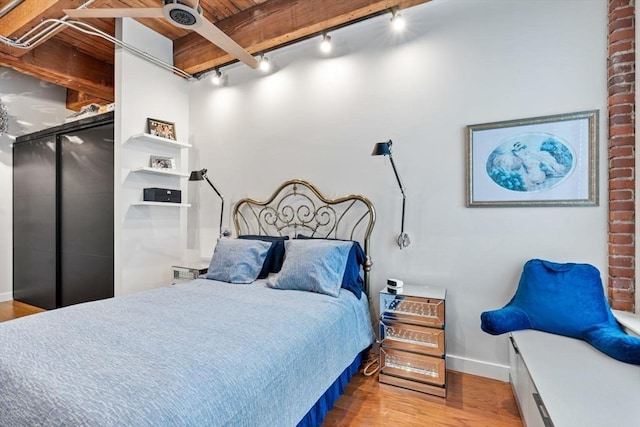 9 W Broadway Unit 311, Boston, MA 02127 - bedroom featuring rail lighting, wood finished floors, and baseboards