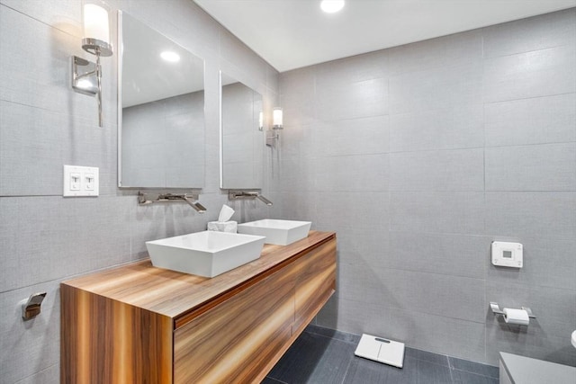 9 W Broadway Unit 311, Boston, MA 02127 - bathroom with tile walls, double vanity, recessed lighting, toilet, and tile patterned floors
