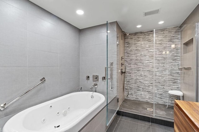 9 W Broadway Unit 311, Boston, MA 02127 - full bath with tile walls, a stall shower, a whirlpool tub, tile patterned floors, and recessed lighting