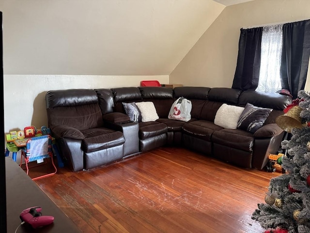 living room with hardwood / wood-style floors and vaulted ceiling