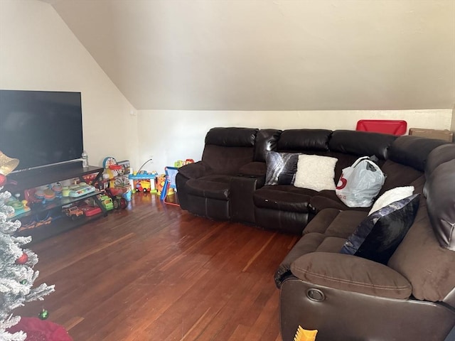 living room featuring dark hardwood / wood-style floors and vaulted ceiling