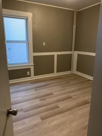 unfurnished room with wood-type flooring and a wealth of natural light