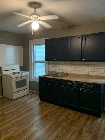 kitchen with decorative backsplash, dark hardwood / wood-style floors, ceiling fan, and gas range gas stove