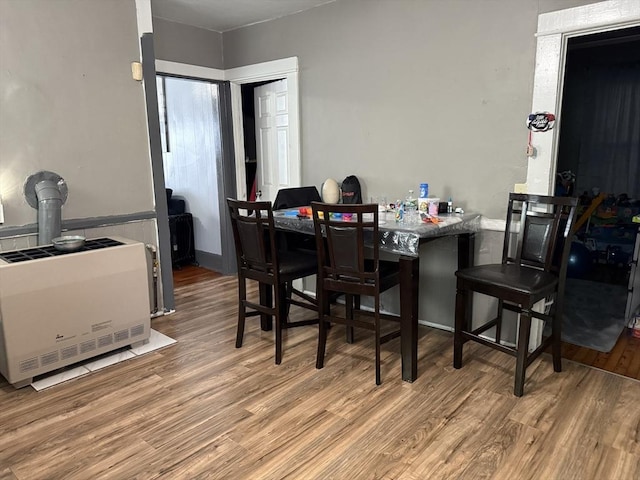 dining area featuring hardwood / wood-style flooring and heating unit