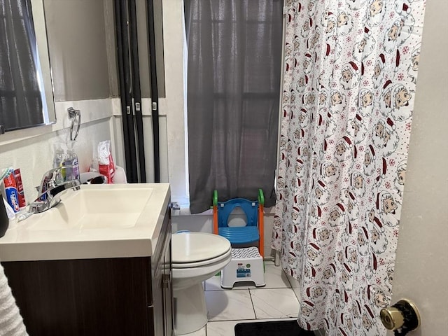 bathroom featuring tile patterned floors, vanity, toilet, and curtained shower