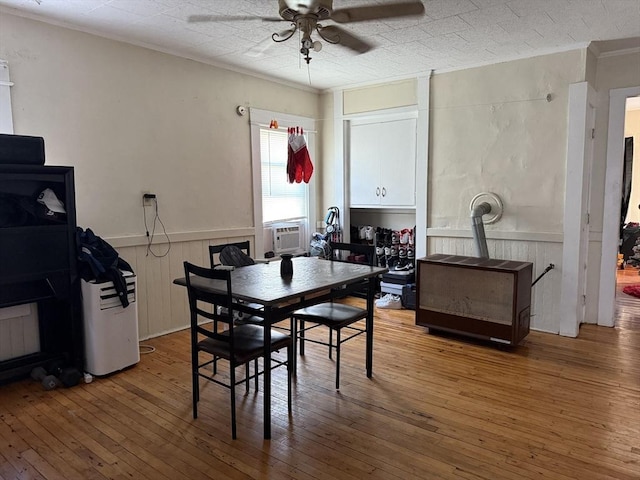 dining space featuring ceiling fan, cooling unit, and wood-type flooring