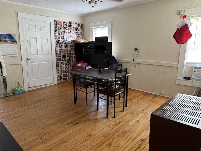 dining area with crown molding, light hardwood / wood-style flooring, and ceiling fan