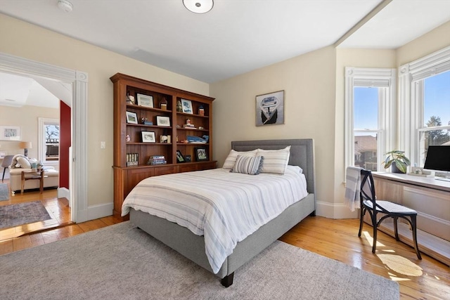 bedroom featuring wood-type flooring and baseboards