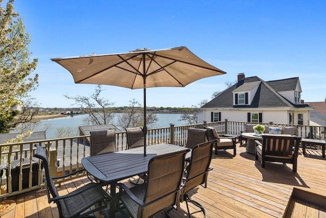 wooden deck featuring outdoor dining space, a water view, and outdoor lounge area