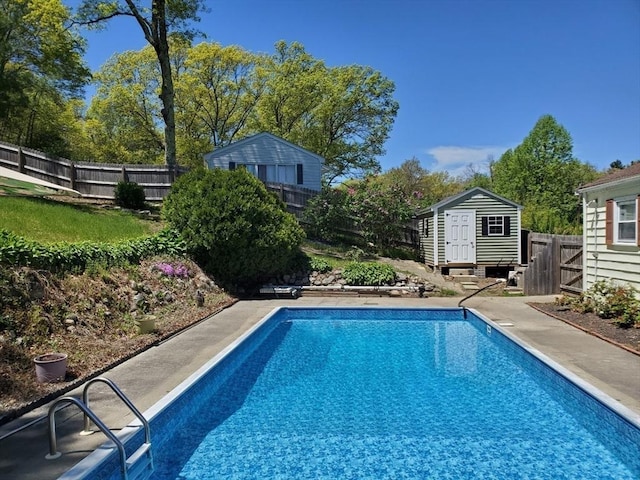 view of swimming pool featuring a storage shed