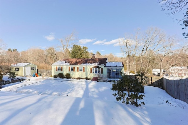 single story home featuring a storage shed