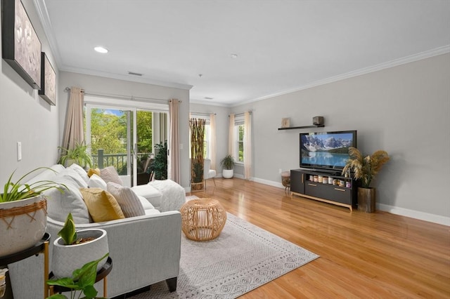 living area featuring wood finished floors, baseboards, ornamental molding, and recessed lighting