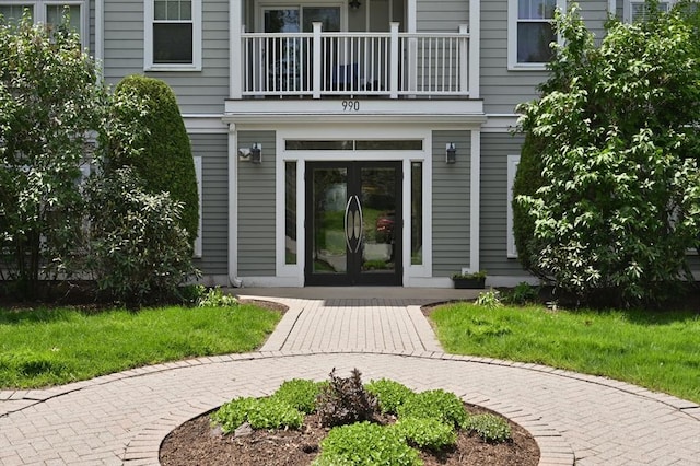 entrance to property with a balcony and french doors