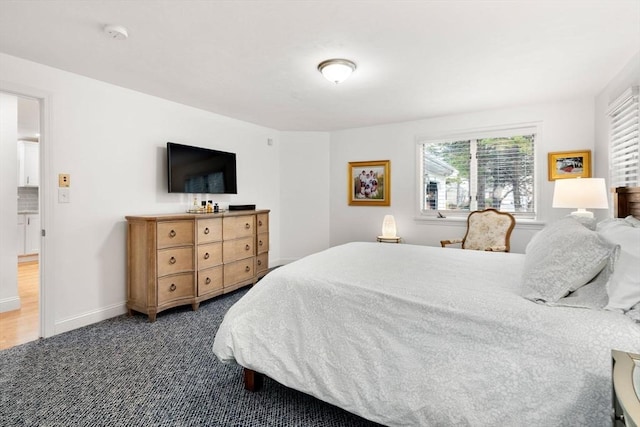 bedroom featuring carpet flooring and baseboards