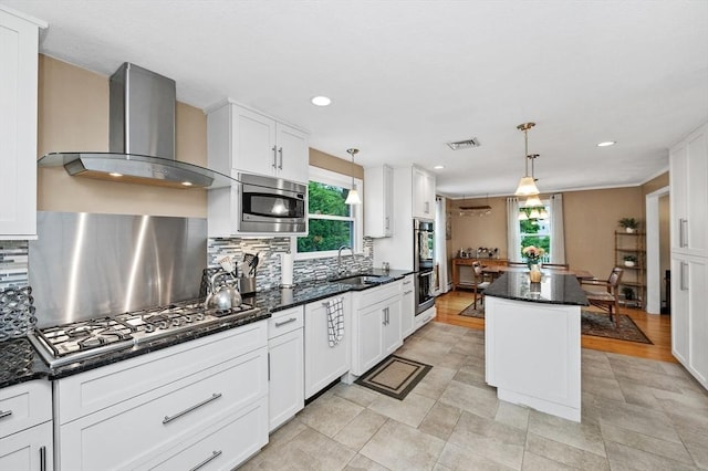 92 Gregory St, Waltham, MA 02451 - kitchen featuring wall chimney exhaust hood, appliances with stainless steel finishes, a center island, backsplash, and recessed lighting