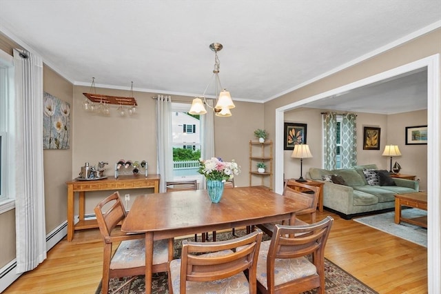 92 Gregory St, Waltham, MA 02451 - dining space featuring light wood finished floors, a chandelier, and crown molding