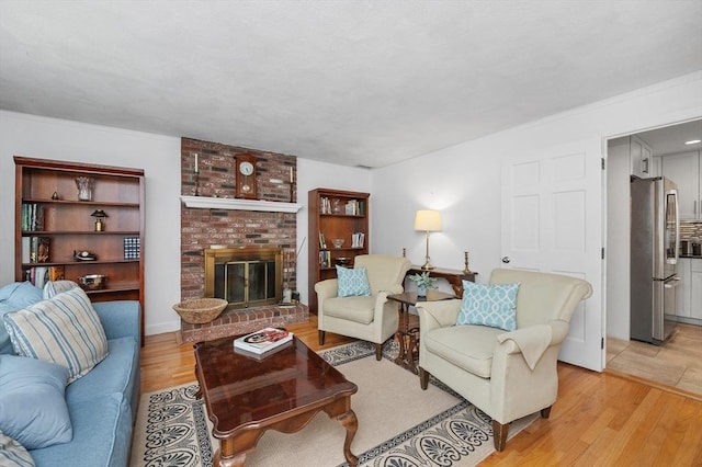 92 Gregory St, Waltham, MA 02451 - living room featuring light wood-style floors and a fireplace