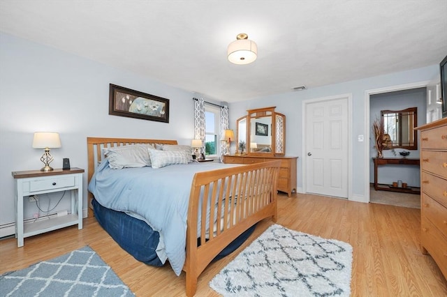 92 Gregory St, Waltham, MA 02451 - bedroom featuring light wood finished floors and a baseboard radiator