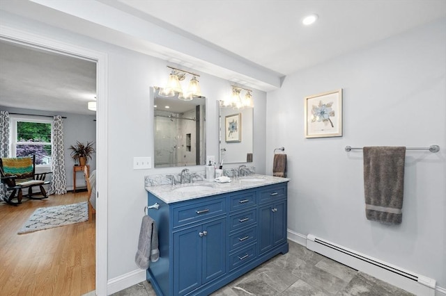 92 Gregory St, Waltham, MA 02451 - full bath with a baseboard heating unit, double vanity, a chandelier, and a shower stall