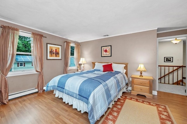 92 Gregory St, Waltham, MA 02451 - bedroom featuring baseboard heating, wood finished floors, and ornamental molding
