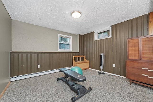 92 Gregory St, Waltham, MA 02451 - exercise room with a baseboard heating unit, carpet flooring, a textured ceiling, and wooden walls