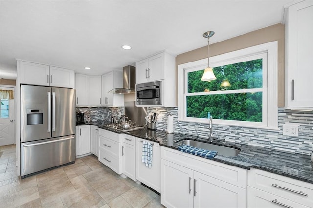 92 Gregory St, Waltham, MA 02451 - kitchen with appliances with stainless steel finishes, wall chimney exhaust hood, white cabinets, decorative backsplash, and dark stone counters
