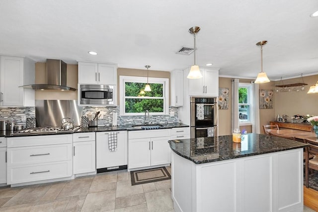 92 Gregory St, Waltham, MA 02451 - kitchen with wall chimney range hood, appliances with stainless steel finishes, backsplash, white cabinets, and recessed lighting