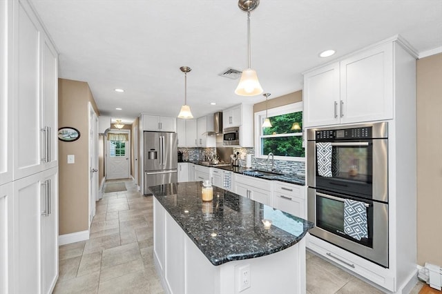 92 Gregory St, Waltham, MA 02451 - kitchen featuring stainless steel appliances, plenty of natural light, tasteful backsplash, white cabinets, and recessed lighting