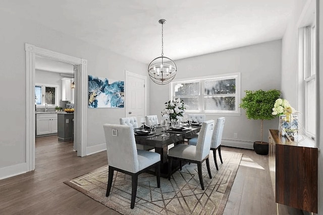 61 E Main, Merrimac, MA 01860 - dining room featuring a chandelier, wood finished floors, and baseboard heating